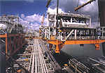 Lifting the pre-assembled units (PAUs) onto the Northern Endeavour at the Sembawang shipyard, in Singapore.